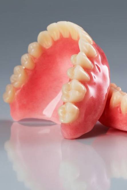 A pair of dentures on a sleek countertop