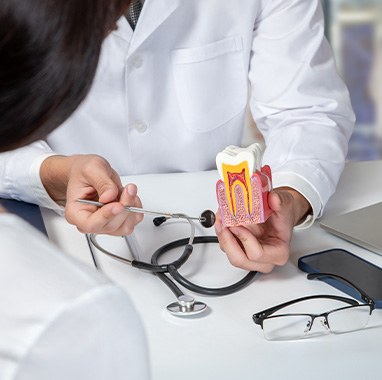 a dentist explaining root canal treatment