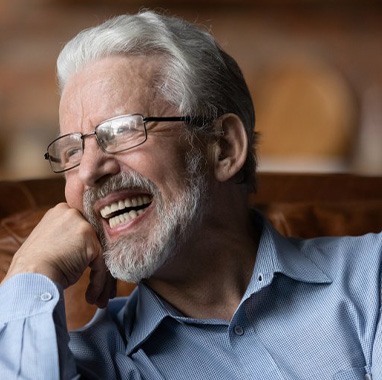 Senior man smiling with his new dentures