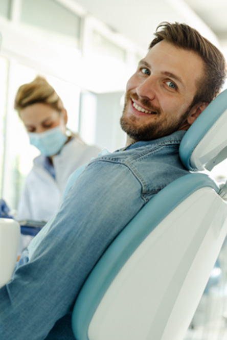 Man smiling while relaxing in treatment chair